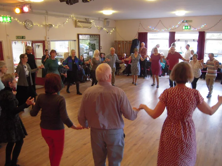 A large circle of dancers