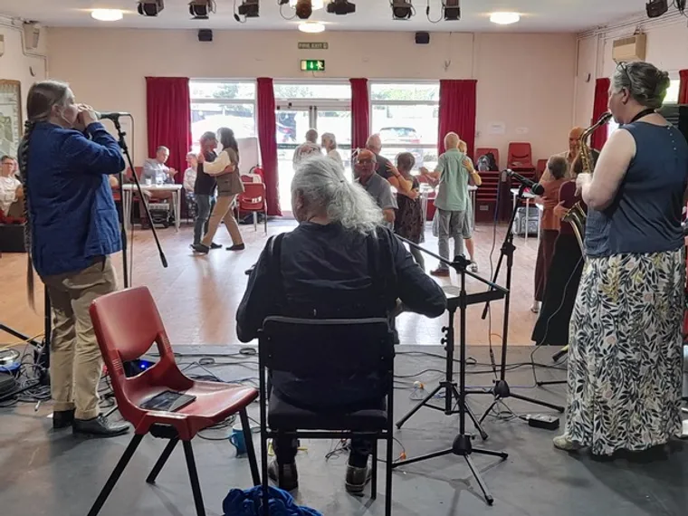 View from the stage, showing 3 musicians playing for dancers